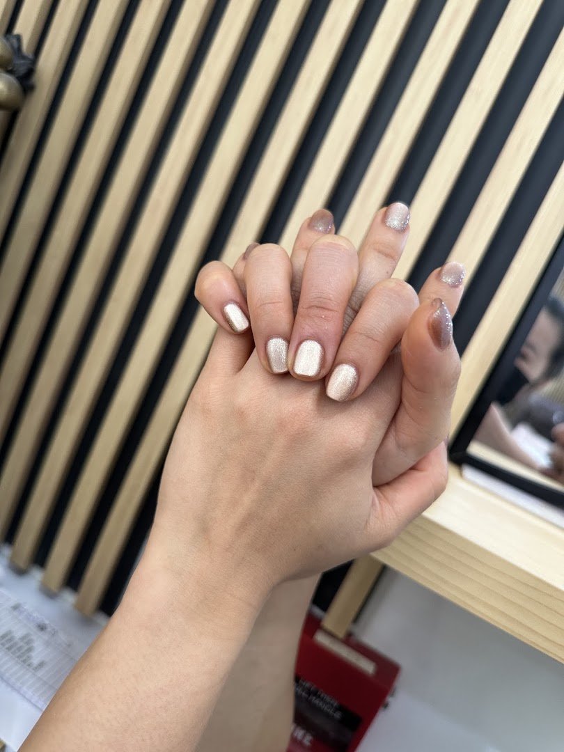 Manicured nails displayed on a salon hand.